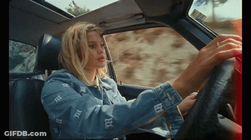 A Woman In A Denim Jacket With The Letter B On It GIF
