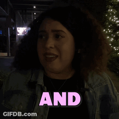 A Woman In A Denim Jacket With The Word Was Written On It GIF