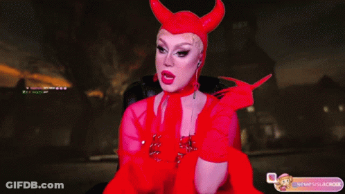 A Woman In A Devil Costume Is Sitting In A Chair With Her Mouth Open GIF