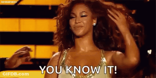 A Woman In A Dress Is Holding Her Hair And Saying `` You Know It '' . GIF