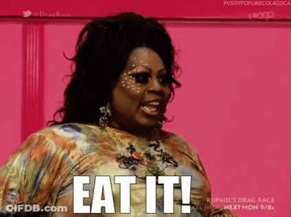 A Woman In A Dress Is Saying Eat It . GIF