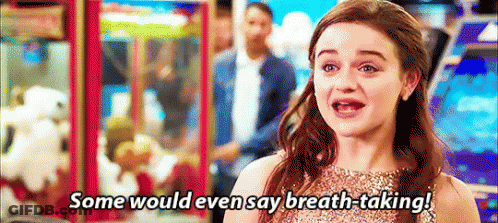 A Woman In A Dress Is Saying `` Some Would Even Say Breath-Taking '' In An Arcade . GIF