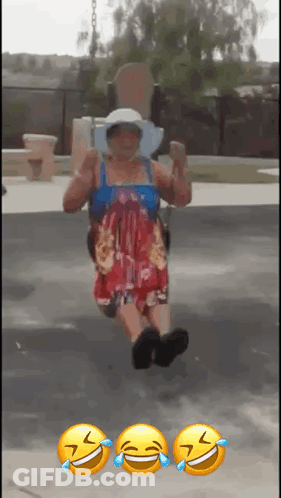 A Woman In A Dress Is Sitting On A Swing With Three Smiley Faces On The Ground Behind Her GIF