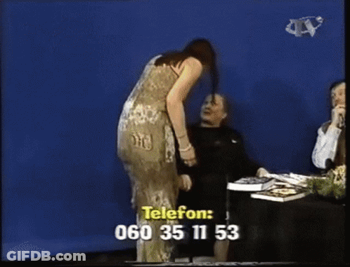A Woman In A Dress Is Standing In Front Of A Blue Screen With A Phone Number Written On It GIF