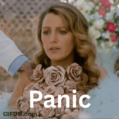 A Woman In A Dress With Roses On It Is Being Held By Someone And The Word Panic Is Above Her GIF