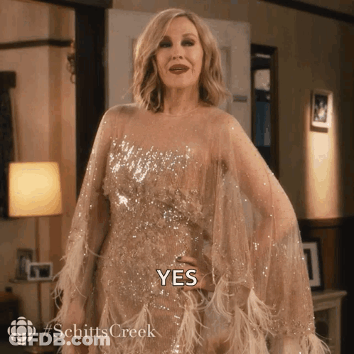 A Woman In A Dress With The Word Yes Written On It GIF