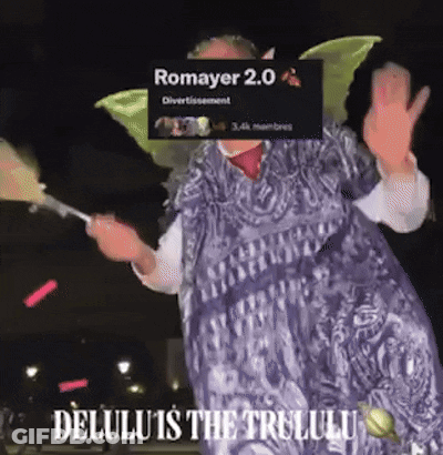 A Woman In A Fairy Costume Is Holding A Fan And Says Romayer 2.0 Delulu Is The Trululu GIF