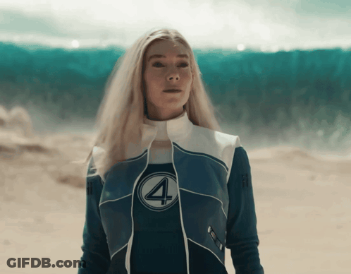 A Woman In A Fantastic Four Costume Stands In The Desert GIF