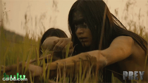 A Woman In A Field With The Word Prey On The Bottom Right GIF