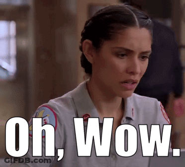 A Woman In A Firefighter Uniform Is Sitting At A Table With The Words Oh Wow Written Above Her . GIF