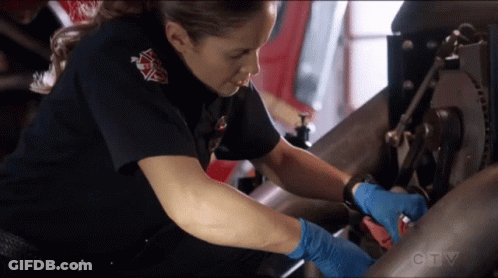 A Woman In A Firefighter Uniform Is Working On A Machine With A Ctv Logo In The Background GIF