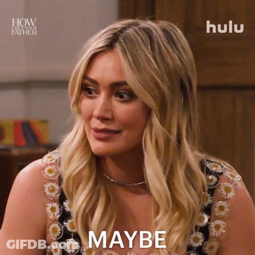 A Woman In A Floral Dress Says Maybe In Front Of A Hulu Logo GIF