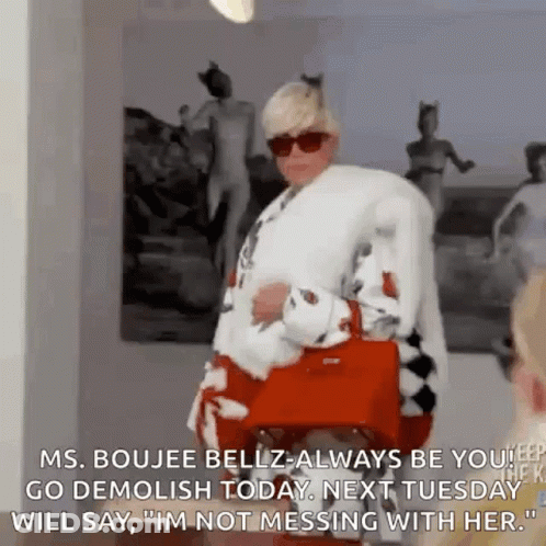 A Woman In A Fur Coat And Sunglasses Is Holding A Red Purse And Talking To Another Woman . GIF