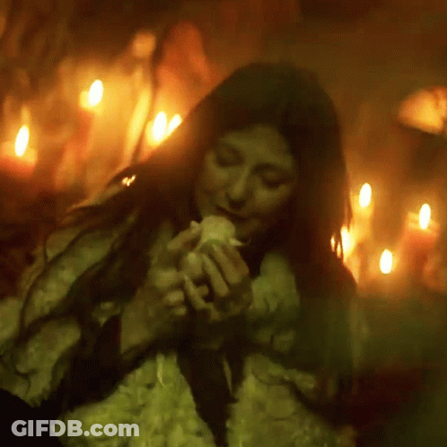 Woman In Fur Coat Holding Candle GIF