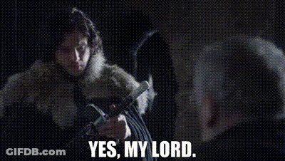 A Woman In A Fur Coat Is Holding A Sword And Talking To A Man In A Dark Room . GIF