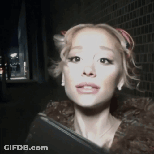 A Woman In A Fur Coat Is Looking At The Camera With A Serious Look On Her Face GIF