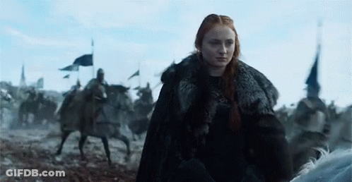 A Woman In A Fur Coat Is Riding A Horse In A Field With Soldiers On Horses . GIF