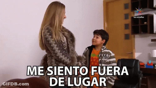 A Woman In A Fur Coat Is Talking To A Young Boy Who Is Wearing A Shirt That Says ' Tommy Hilfiger ' GIF