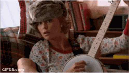 Woman In Fur Hat Playing Banjo And Guitar GIF