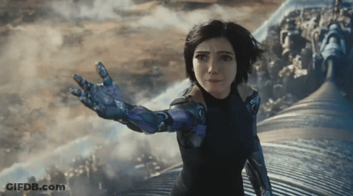 A Woman In A Futuristic Suit Reaches Out Her Hand GIF