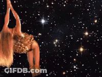 A Woman In A Gold Dress Is Flying Through The Air Surrounded By Stars GIF