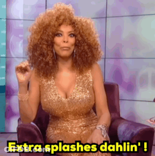 A Woman In A Gold Dress Is Sitting In A Chair And Saying Extra Splashes Dahlin ' ! GIF