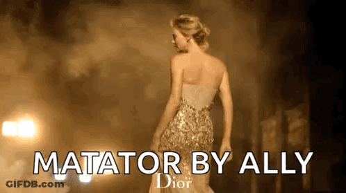 A Woman In A Gold Dress Is Standing In Front Of A Dark Background . GIF