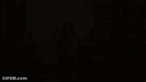 A Woman In A Gold Dress Is Surrounded By A Group Of Women GIF