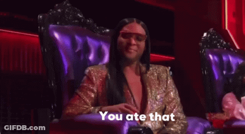 A Woman In A Gold Jacket Is Sitting In A Purple Chair And Talking . GIF