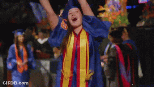 A Woman In A Graduation Cap And Gown With The Number 80 On Her Shirt GIF