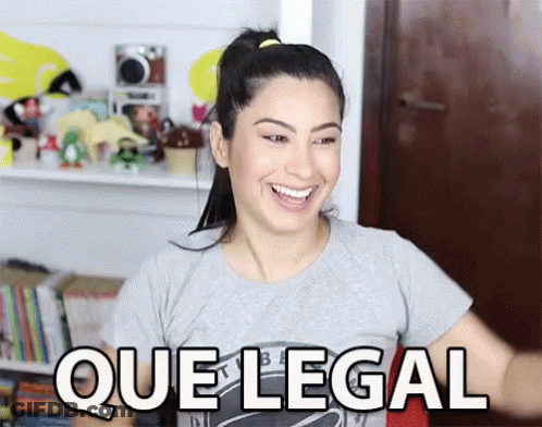 A Woman In A Gray Shirt Is Smiling And Says Que Legal GIF