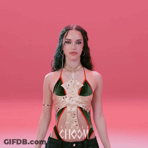 A Woman In A Green And White Top With The Word Choom On Her Chest GIF