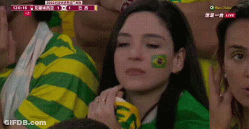 A Woman In A Green And Yellow Striped Shirt Has A Green Circle Painted On Her Face GIF