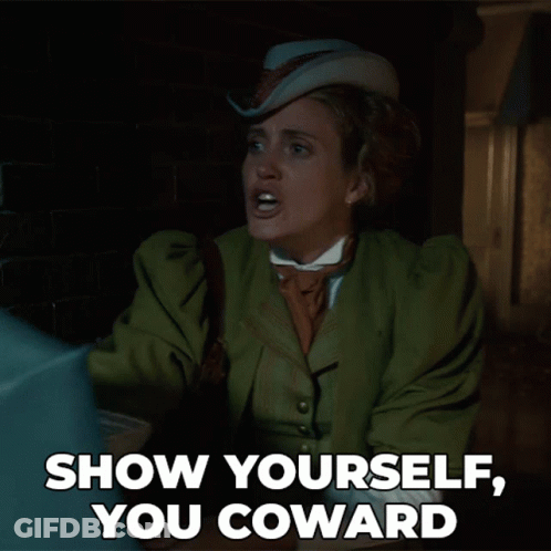 A Woman In A Green Coat And Hat Says " Show Yourself You Coward " GIF