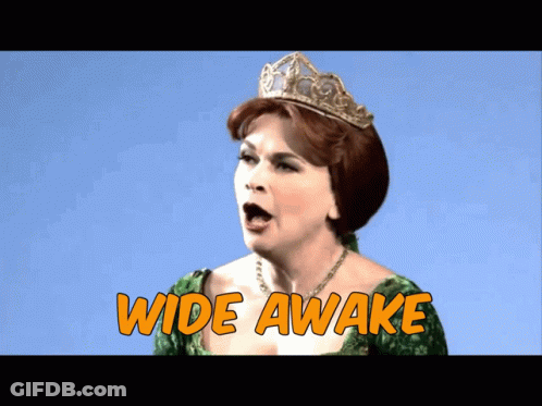 A Woman In A Green Dress And A Tiara Says Wide Awake GIF