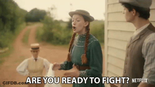 A Woman In A Green Dress And Hat Is Standing Next To A Man And A Woman And Says Are You Ready To Fight ? GIF