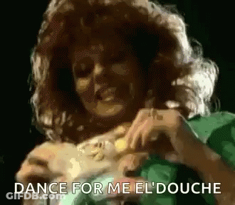 A Woman In A Green Dress Is Dancing With The Words Dance For Me El Douche Above Her GIF