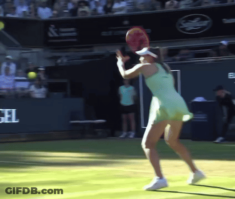 A Woman In A Green Dress Is Holding A Tennis Racket On A Tennis Court GIF