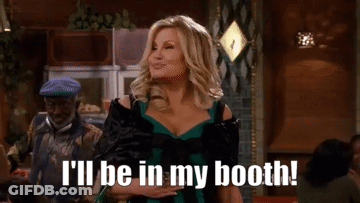 A Woman In A Green Dress Is Saying I 'Ll Be In My Booth . GIF
