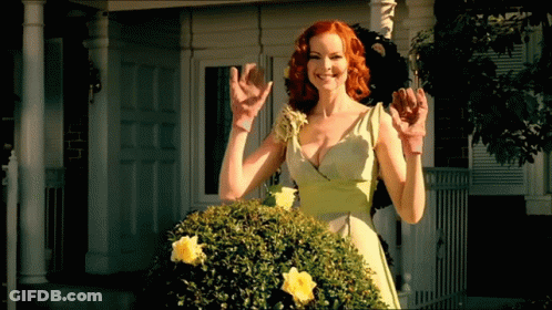 A Woman In A Green Dress Is Standing In Front Of A White House GIF