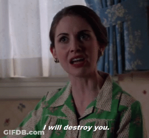 A Woman In A Green Dress Is Talking And Says I Will Destroy You . GIF