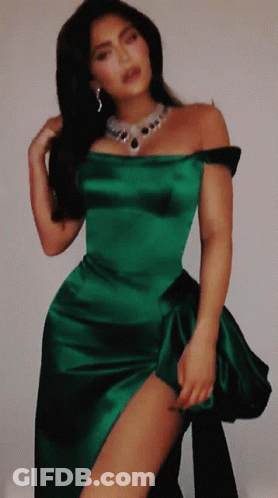 A Woman In A Green Dress With A Necklace On GIF