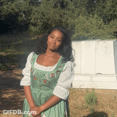 A Woman In A Green Dress With Flowers On It GIF