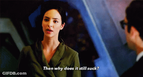 A Woman In A Green Jacket Is Talking To A Man And Says Then Why Does It Still Suck GIF