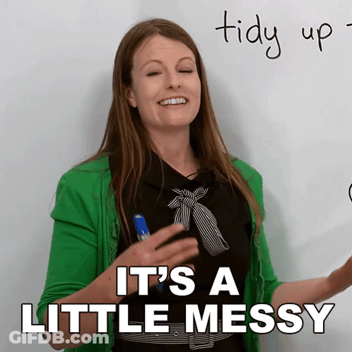 A Woman In A Green Jacket Says It 'S A Little Messy In Front Of A Whiteboard GIF
