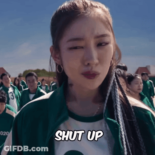 A Woman In A Green Jacket Says Shut Up In Front Of A Crowd GIF