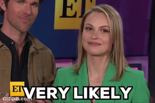 A Woman In A Green Jacket Says Very Likely Next To A Man GIF