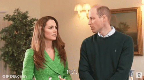 A Woman In A Green Jacket Stands Next To A Man In A Green Sweater And Says No GIF