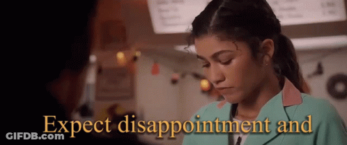 A Woman In A Green Jacket With The Words Expect Disappointment And Written On It GIF
