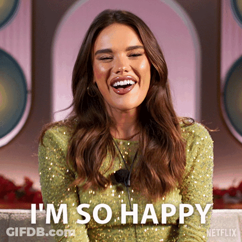 A Woman In A Green Sequined Dress Is Smiling And Says I 'M So Happy GIF